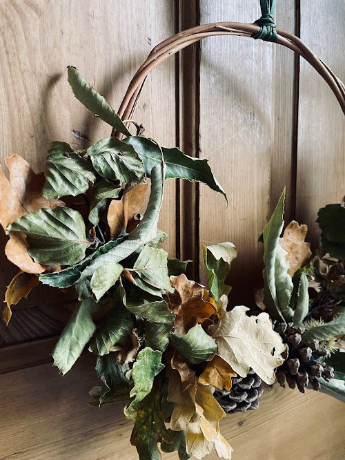 Rustic autumn wreath on a willow base and green ribbon