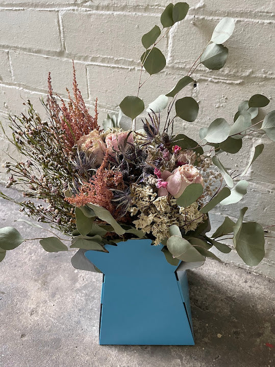 Sage green and pink bouquet in a sky blue hat box