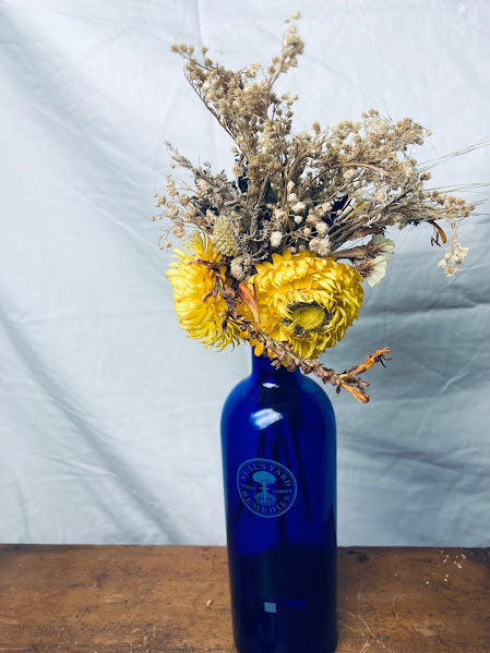 Neal's Yard blue glass bottle 100ml with sunny strawflowers and grasses