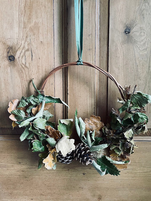 Rustic autumn wreath on a willow base and green ribbon