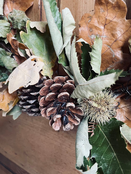 Rustic autumn wreath on a willow base and green ribbon