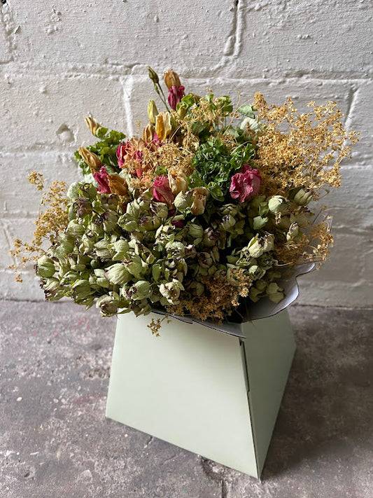 Pink rose and light green bouquent in a pale green hat box