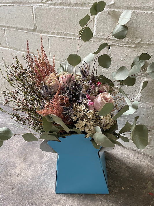 Sage green and pink bouquet in a sky blue hat box